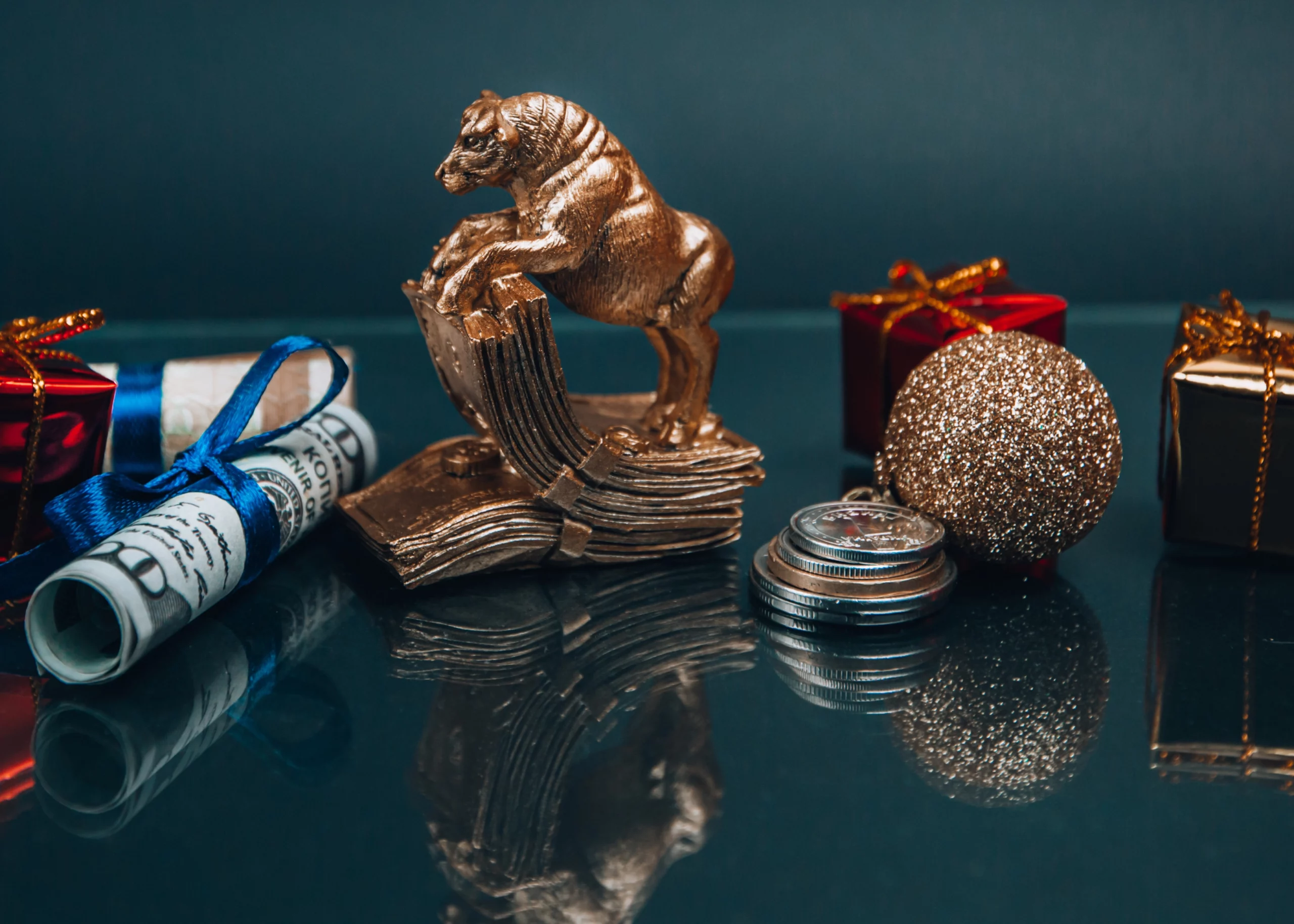 Golden ox souvenir and New Year decorations composed with dollar bills and coins